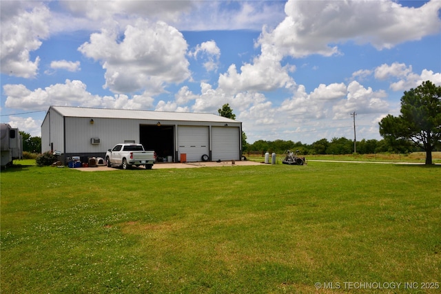 27855 S 170th Rd, Henryetta, OK 74437 - back of property featuring a detached garage, a lawn, and an outbuilding