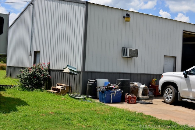 27855 S 170th Rd, Henryetta, OK 74437 - view of home's exterior featuring a pole building, a lawn, a wall mounted AC, and an outdoor structure
