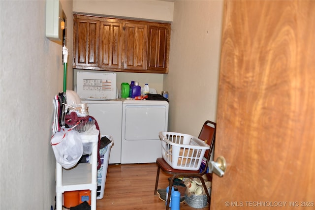 27855 S 170th Rd, Henryetta, OK 74437 - washroom featuring washer and clothes dryer, wood finished floors, and cabinet space