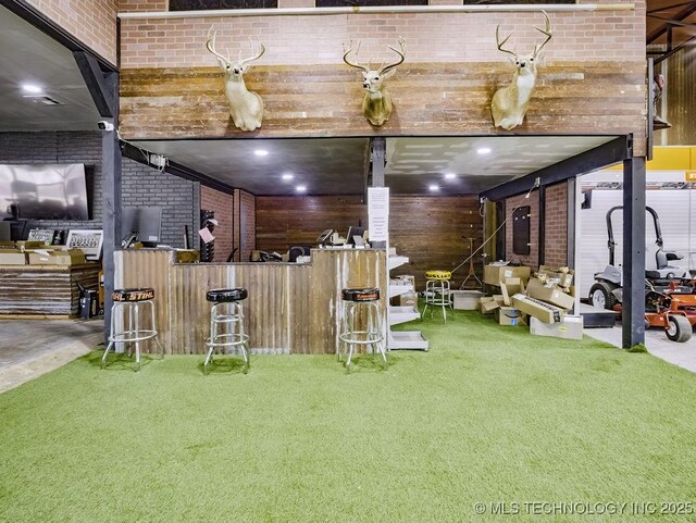 824 S California, Atoka, OK 74525 - bar area featuring carpet, brick wall, and wood walls