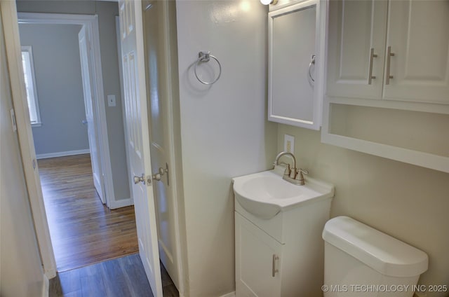 3833 E 22nd St, Tulsa, OK 74114 - half bath featuring vanity and wood finished floors