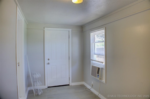 3833 E 22nd St, Tulsa, OK 74114 - foyer featuring light wood finished floors, a textured ceiling, and cooling unit