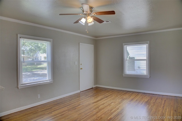 3833 E 22nd St, Tulsa, OK 74114 - spare room with healthy amount of natural light, wood finished floors, a ceiling fan, and crown molding