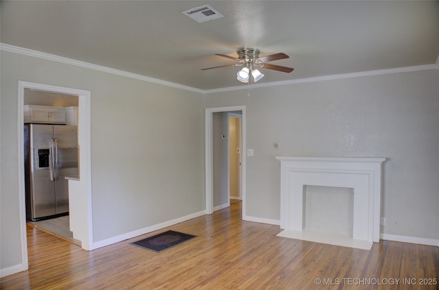 3833 E 22nd St, Tulsa, OK 74114 - unfurnished living room featuring a ceiling fan, wood finished floors, and crown molding