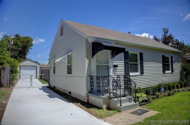 3833 E 22nd St, Tulsa, OK 74114 - bungalow-style home featuring driveway, a detached garage, an outbuilding, crawl space, and roof with shingles