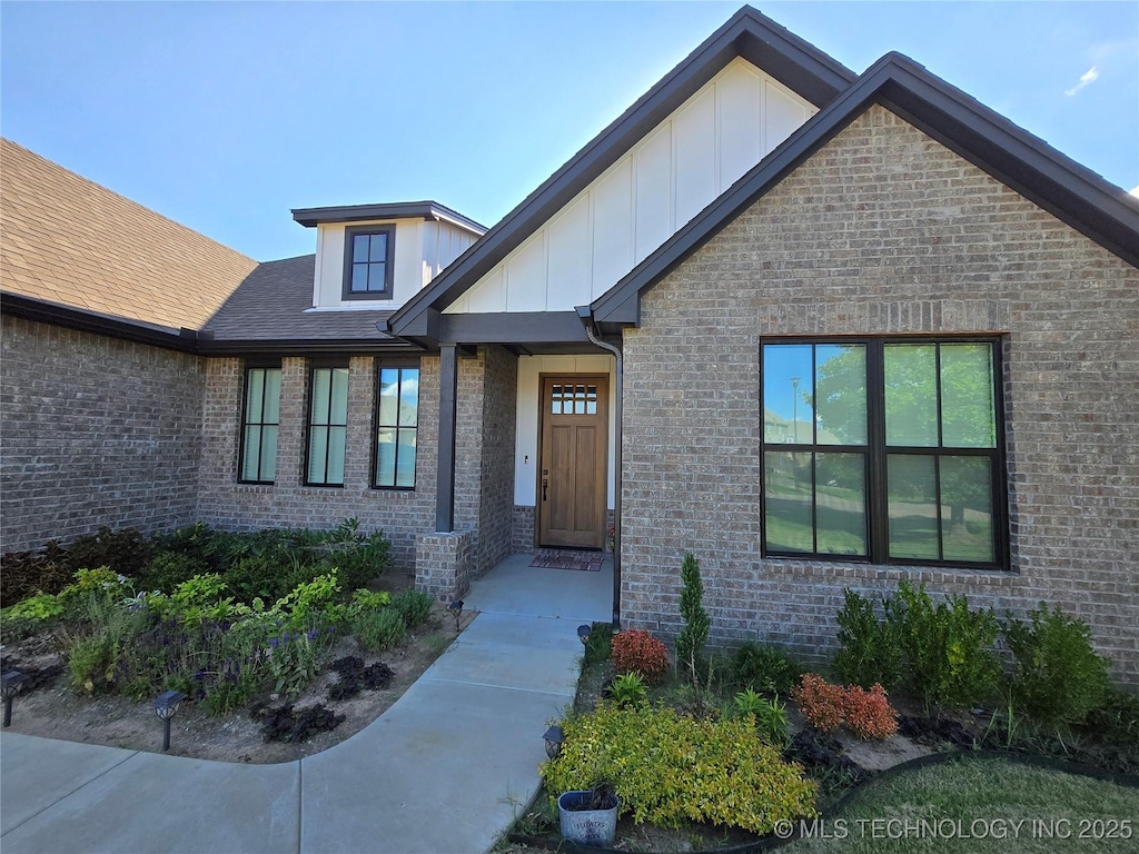 3610 S Fir Ct W, Broken Arrow, OK 74011 - doorway to property featuring board and batten siding and brick siding