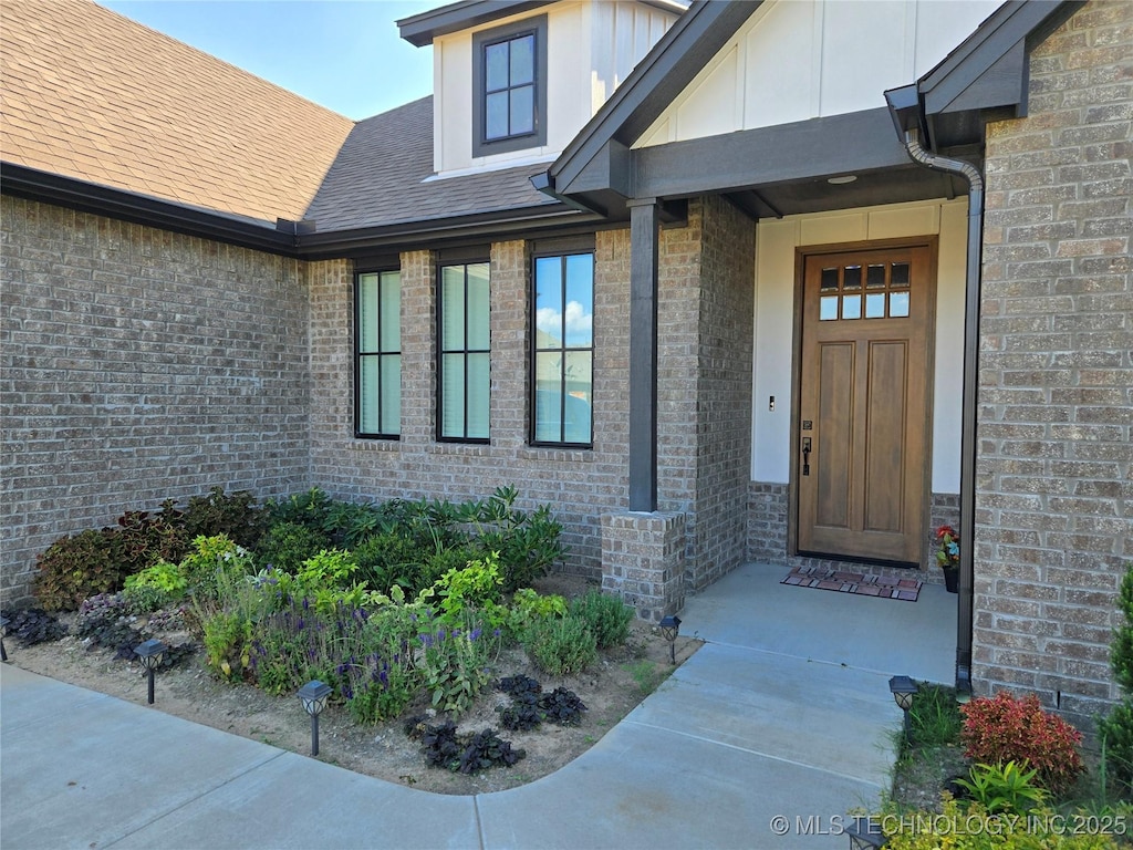 3610 S Fir Ct W, Broken Arrow, OK 74011 - view of exterior entry with brick siding and roof with shingles