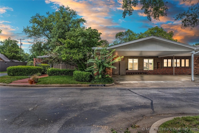 view of front of home featuring a carport and brick siding