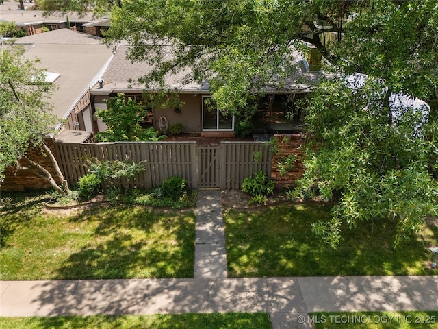 view of front of property featuring a gate and brick siding
