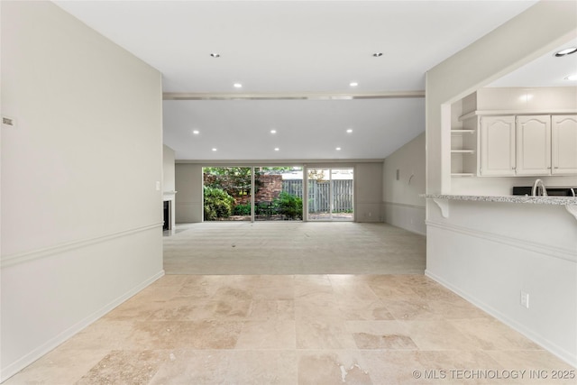 unfurnished living room featuring recessed lighting and a fireplace