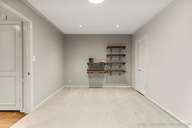 empty room featuring recessed lighting, light carpet, and crown molding