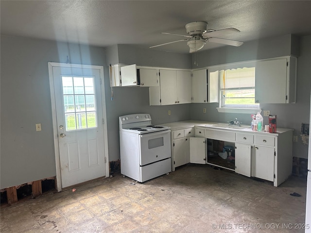 200 W Polk, Mcalester, OK 74501 - kitchen featuring white electric stove, plenty of natural light, white cabinetry, and a textured ceiling