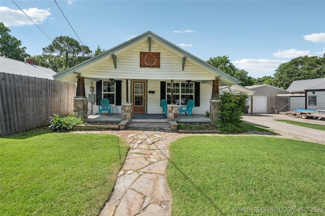 606 Goingsnake St, Tahlequah, OK 74464 - view of front of home with a porch, driveway, a garage, and an outbuilding