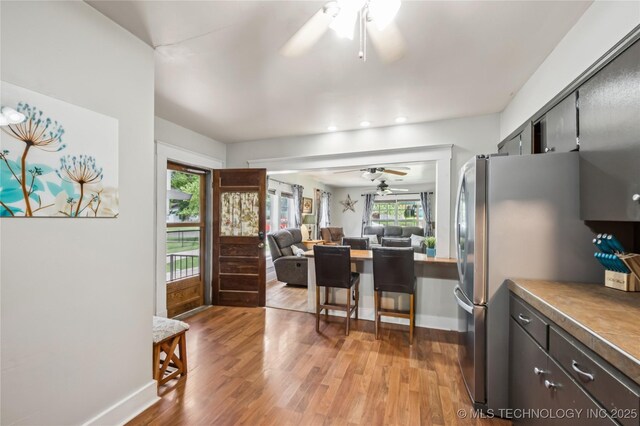 606 Goingsnake St, Tahlequah, OK 74464 - kitchen featuring a ceiling fan, light wood-style flooring, freestanding refrigerator, recessed lighting, and open floor plan