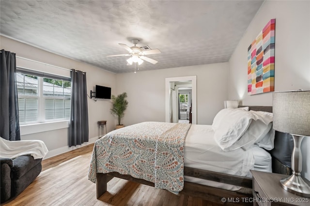 606 Goingsnake St, Tahlequah, OK 74464 - bedroom featuring wood finished floors and ceiling fan