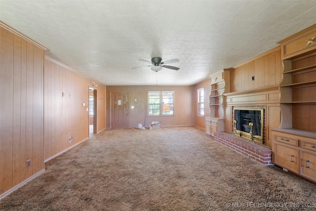 522 E 6th St, Claremore, OK 74017 - unfurnished living room with ceiling fan, wooden walls, a brick fireplace, carpet floors, and ornamental molding
