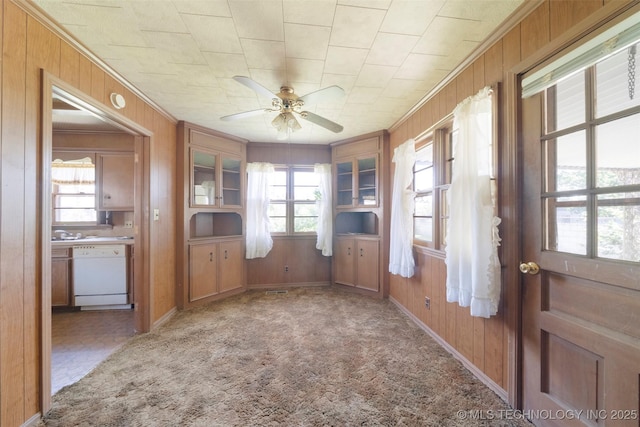 522 E 6th St, Claremore, OK 74017 - entrance foyer with wooden walls, ceiling fan, crown molding, and light carpet