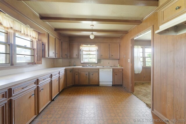 522 E 6th St, Claremore, OK 74017 - kitchen featuring dishwasher, light flooring, beam ceiling, light countertops, and wooden walls