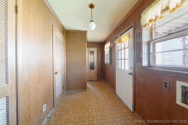 522 E 6th St, Claremore, OK 74017 - doorway featuring light flooring, wood walls, and crown molding