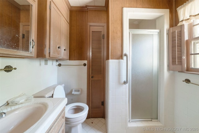 522 E 6th St, Claremore, OK 74017 - bathroom featuring tile walls, a shower stall, a closet, tile patterned floors, and vanity