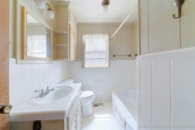 522 E 6th St, Claremore, OK 74017 - bathroom featuring healthy amount of natural light, tile walls, tile patterned floors, vanity, and crown molding