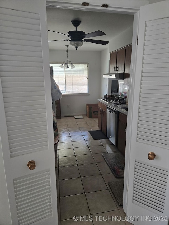6920 E 20th St, Tulsa, OK 74112 - kitchen featuring stainless steel dishwasher, ceiling fan, dark tile patterned flooring, under cabinet range hood, and dark brown cabinetry