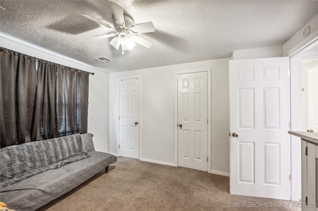 1105 S Maple Ave, Tahlequah, OK 74464 - living area with a ceiling fan, carpet flooring, and a textured ceiling