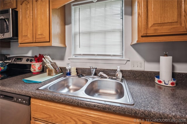 1105 S Maple Ave, Tahlequah, OK 74464 - kitchen with appliances with stainless steel finishes, dark countertops, and brown cabinets