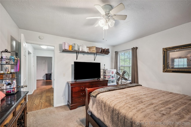 1105 S Maple Ave, Tahlequah, OK 74464 - bedroom with a textured ceiling, light carpet, and a ceiling fan