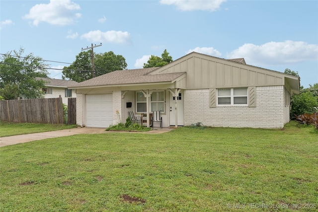 313 E 48th Ave, Tulsa, OK 74105 - view of front facade featuring brick siding, a garage, driveway, and board and batten siding