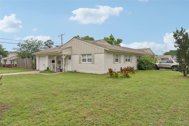313 E 48th Ave, Tulsa, OK 74105 - ranch-style house with an attached garage, a front yard, concrete driveway, and brick siding