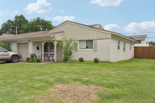 313 E 48th Ave, Tulsa, OK 74105 - view of front facade with an attached garage, board and batten siding, and brick siding