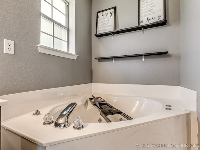 1604 W Los Angeles Cir, Broken Arrow, OK 74011 - bathroom with a tub with jets and a textured wall