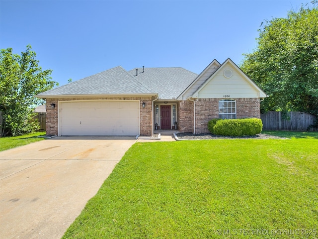 1604 W Los Angeles Cir, Broken Arrow, OK 74011 - view of front facade featuring a garage, driveway, brick siding, and a shingled roof