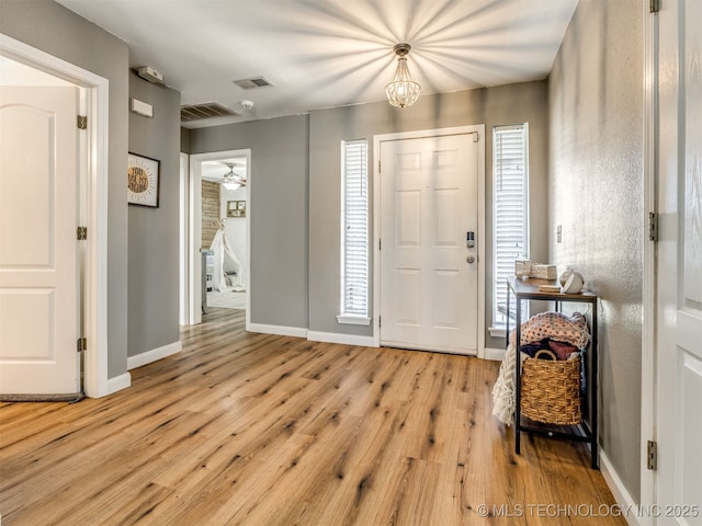 1604 W Los Angeles Cir, Broken Arrow, OK 74011 - foyer entrance featuring light wood finished floors and a chandelier
