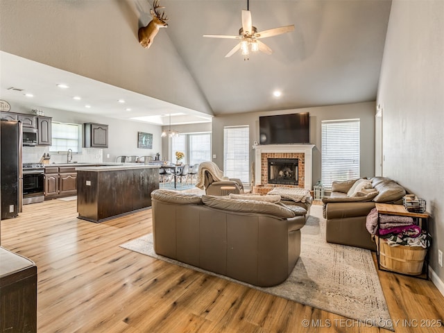 1604 W Los Angeles Cir, Broken Arrow, OK 74011 - living room with light wood-style flooring, a ceiling fan, high vaulted ceiling, healthy amount of natural light, and recessed lighting
