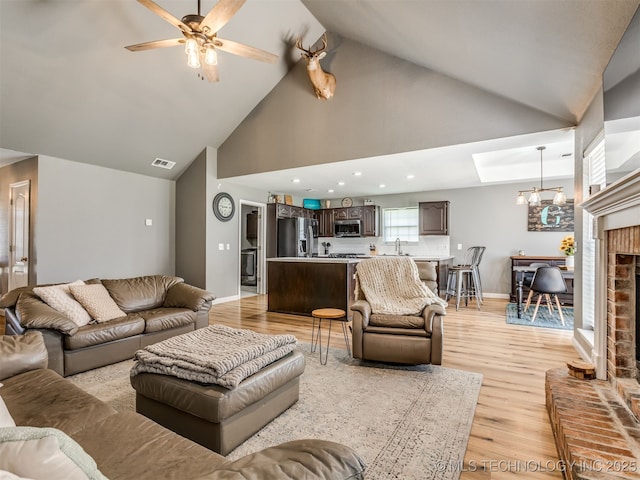 1604 W Los Angeles Cir, Broken Arrow, OK 74011 - living area featuring light wood-style flooring, a ceiling fan, high vaulted ceiling, recessed lighting, and a fireplace