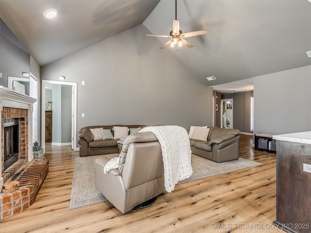1604 W Los Angeles Cir, Broken Arrow, OK 74011 - living room featuring high vaulted ceiling, a ceiling fan, a fireplace, and wood finished floors
