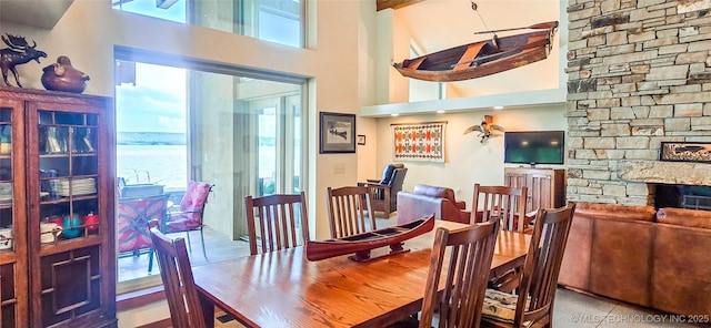 117189 S 4238th Rd, Eufaula, OK 74432 - dining space with a towering ceiling, a stone fireplace, and a water view