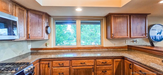 117189 S 4238th Rd, Eufaula, OK 74432 - kitchen featuring stainless steel appliances, brown cabinets, recessed lighting, decorative backsplash, and stone counters