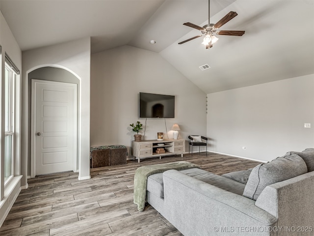2008 E Union St, Broken Arrow, OK 74011 - living room with ceiling fan, arched walkways, light wood-style floors, vaulted ceiling, and plenty of natural light