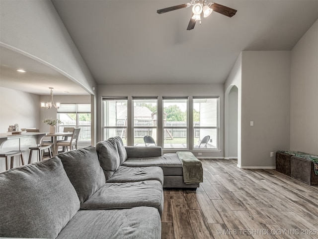2008 E Union St, Broken Arrow, OK 74011 - living area with arched walkways, wood finished floors, a ceiling fan, a chandelier, and high vaulted ceiling