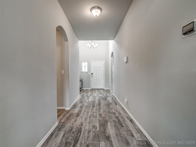 2008 E Union St, Broken Arrow, OK 74011 - corridor featuring arched walkways, dark wood-style flooring, and a chandelier