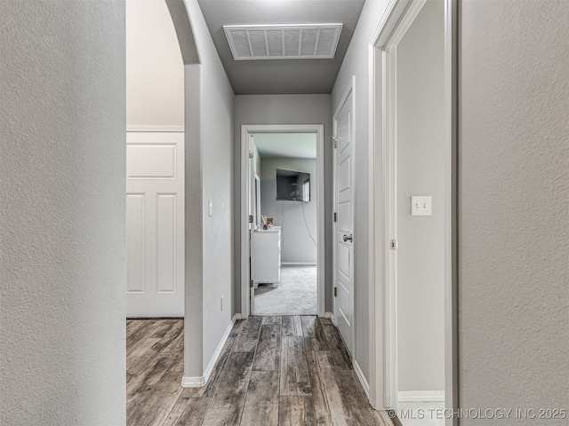 2008 E Union St, Broken Arrow, OK 74011 - corridor with dark wood-style floors, a textured wall, and arched walkways