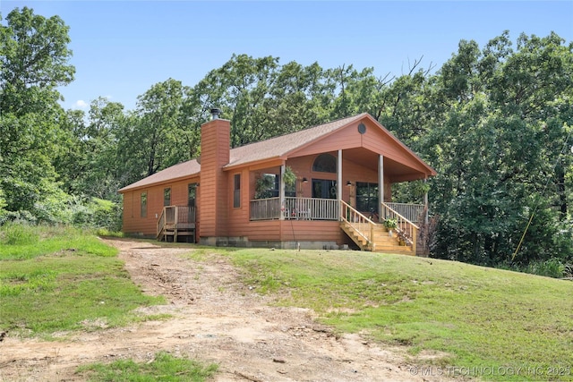 14629 E 233rd St S, Webbers Falls, OK 74470 - view of front facade with a chimney, a porch, a front lawn, and dirt driveway