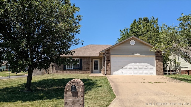 1114 W 22nd St, Claremore, OK 74017 - ranch-style house with brick siding, an attached garage, and driveway