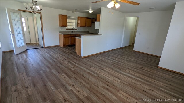 1114 W 22nd St, Claremore, OK 74017 - kitchen featuring light countertops, ceiling fan, dark wood finished floors, and plenty of natural light