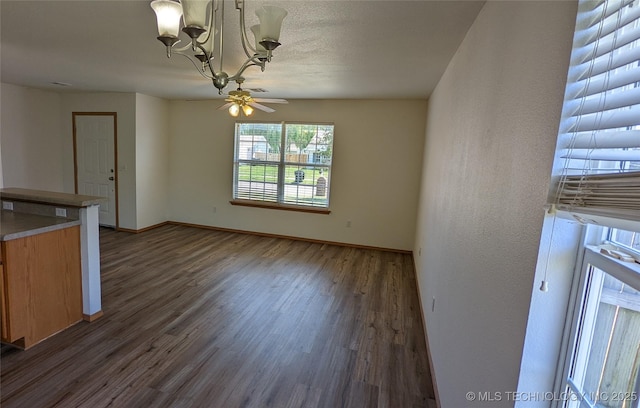 1114 W 22nd St, Claremore, OK 74017 - unfurnished living room with a chandelier, wood finished floors, and ceiling fan
