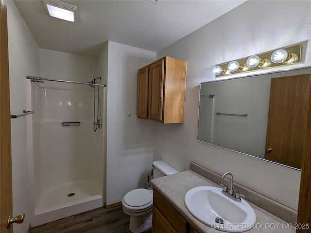 1114 W 22nd St, Claremore, OK 74017 - bathroom with wood finished floors, a shower, and vanity