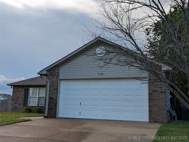 1114 W 22nd St, Claremore, OK 74017 - view of front of house featuring brick siding and driveway